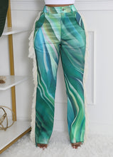 Load image into Gallery viewer, Bring all the drama to your weekend with these Ms. Miami swirl pants. Featuring a relaxing fit designed to cinch the waist while loosely hang on the legs for an hourglass silhouette, and unique twill tassel side detailing, how can you not be obsessed? Style these swirl pants with a statement top, heels and designer sunglasses for a look that will really make you stand out from the crowd.
